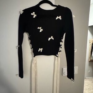 Elegant Black Top with White Bow Accents